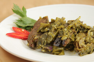 Dendeng balado is a typical cuisine of West Sumatra made from thin and wide slices of beef that are dried and then fried dry. This fried meat is seasoned with green chilli 