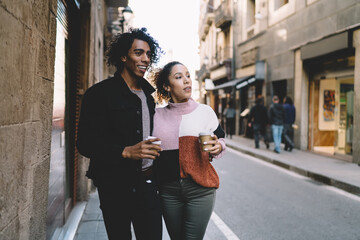 Young couple with takeaway coffee during sightseeing in old town