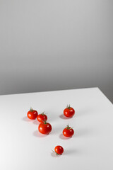 Lots of fresh cherry tomatoes on the white table. Creative art geometric composition concept