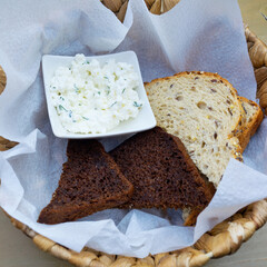 Curd snack with bread in a wicker basket.