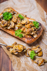 grilled ciabatta sandwich with mushrooms and feta cheese on a wooden board