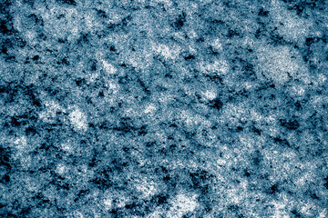 Abstract grainy background with white, blue and black particles