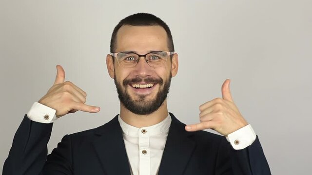 A Young successful businessman asks for a callback and makes a hand gesture.