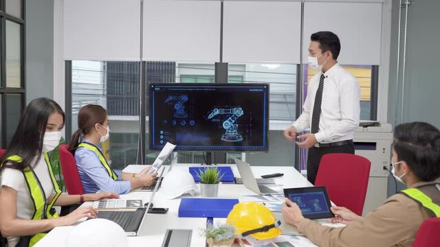 The supervisor of the engineering team is presenting operation of machines in meeting rooms within offices
