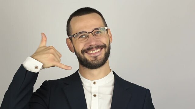 A Young successful businessman asks for a callback and makes a hand gesture.