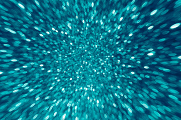 Abstract bokeh background with motion zoom effect toned blue color