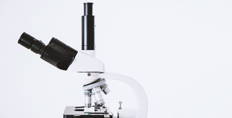 Using a biological microscope. Close up of a microscope. Scientific research concept, using a microscope. Medical examinations, searching for bacteria, diseases, blood tests.