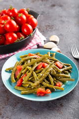 Fresh green cowpea salad with tomato and garlic.