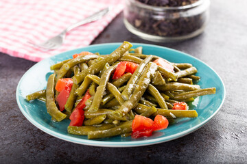 Fresh green cowpea salad with tomato and garlic.