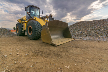 An excavator in a stone turning quarry into gravel