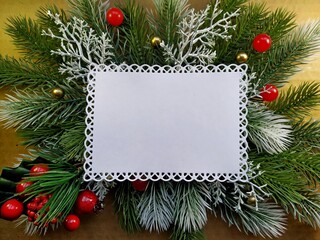 Fototapeta na wymiar christmas background for postcard. fir branches with elements of Christmas decor on red linen burlap