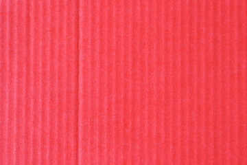 Corrugated colored cardboard of red scarlet vintage color. Textural paper cardboard background