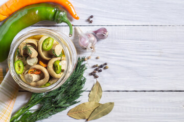 Salted milk mushrooms or pickled milk mushrooms in a glass jar and ingredients