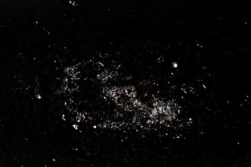 Splash of clear water on black isolated background.