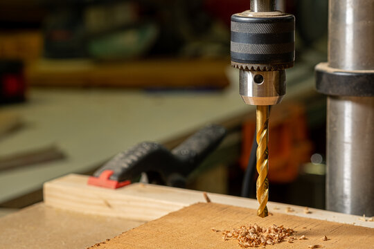 Close up of a drill bit in a drill press in a workshop