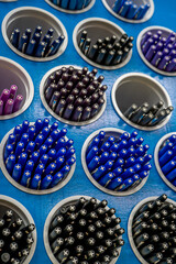 Colorful pens arranged on round shelves selling stationery. Multicolored markers in art store. Workshop, creativity concept.