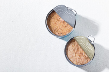 Open can of tuna on white background, close-up image