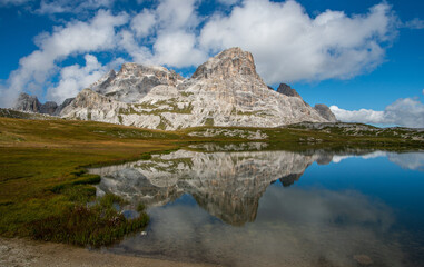 Fototapeta na wymiar an alpine lake with the reflection of the mountains in the Dolomites in South Tyrol, Italy