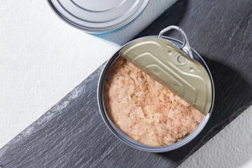 Open can of tuna on white background, close-up image