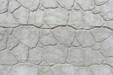 Textured with a pattern, the background of the stone wall is gray