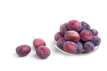 Fresh fruits. Plum on a saucer on a white isolated background. Agricultural products.