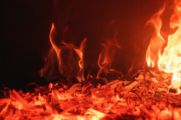 Close-up of red roaring flames burning in fireplace. Romantic and mesmerizing flames.