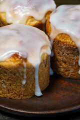 Traditional Easter kulich pastry served on dark brown plate. Wooden table, high resolution