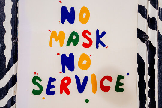 Colorful sign that says No Mask No Service