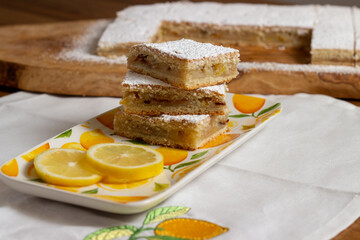 Homemade lemon pie with lemon slices alongside