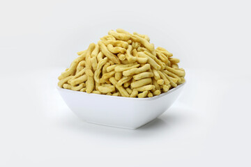 Indian snacks gathiya in white bowl in white background.
