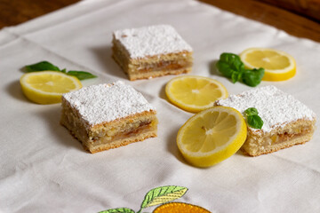 Homemade lemon pie with lemon slices alongside