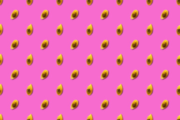 Colored pattern of passion fruit seeds on a pink background.