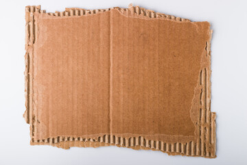 Brown corrugated cardboard sheet with torn edges