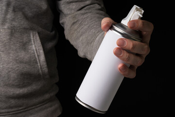 Can with compressed air spray in hand