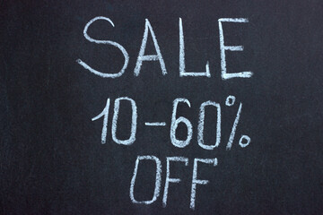 Fototapeta premium The inscription on the chalk board SALE 10-60%. Commercial lettering 