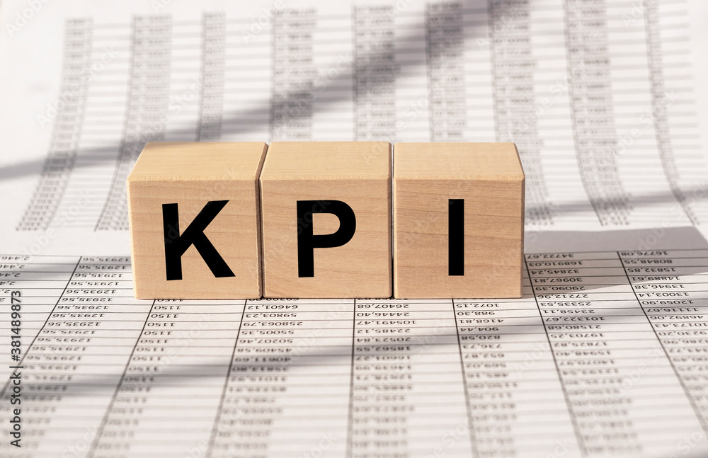 Poster kpi. key performance indicator - cube blocks on financial documents