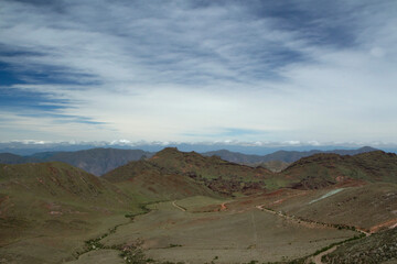 Aerial view of the enchanted Valley in Salta, Argentina. The green meadow, valley and hills under a beautiful blue sky with clouds.