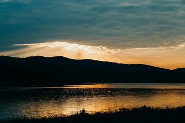 Beautiful golden sunset reflected in lake water. Lake Mucharz. Jezioro Mucharskie, Poland © kvitkanastroyu