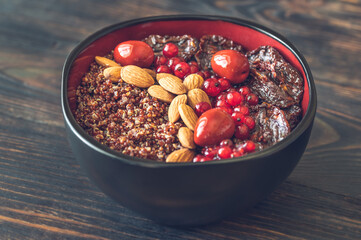 Bowl of red quinoa with nuts and sun-dried tomatoes