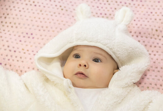 cute baby lying in a white hare costume