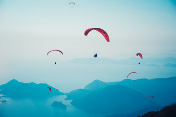 Fethiye, Mugla / Turkey August 28 2020: Paragliding in the sky. Paraglider tandem flying over the...