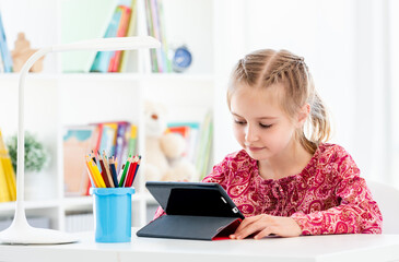 Little girl using tablet at school