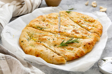 Freshly baked flat garlic bread, foccacia with olive oil and herbs.