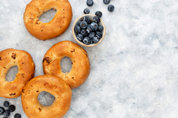 Bagels with cinnamon and blueberry, top view. Copy space.