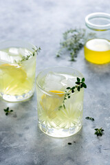 Glass of lemon fresh summer drink in glass. Soda lemonade drink with herb.