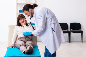 Injured young woman visiting young male doctor