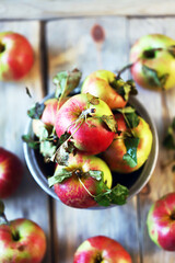 Fresh apples in a bowl on a wooden surface. Harvest apples.