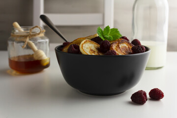 Traditional dutch mini pancakes or poffertjes in a grey bowl