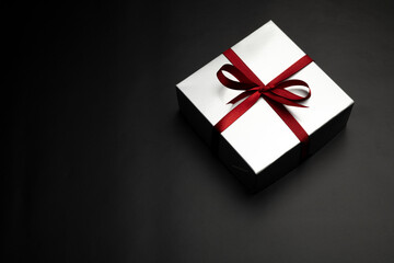 Gift box over black background with copy space