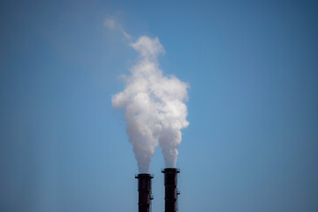 Factory chimney with dirty smoke emitting nature